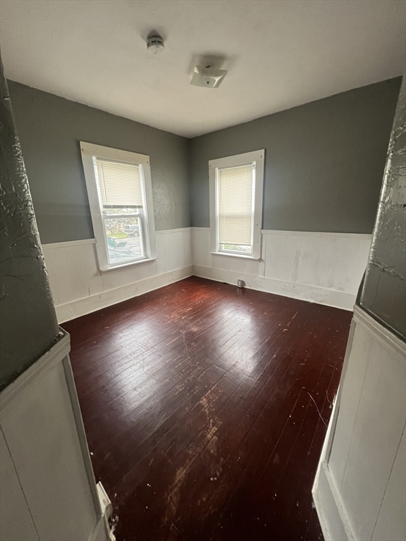 75 Intervale Street, Unit 1 Brockton, MA 02302 - Photo 1 of 11 an empty room with wooden floor and windows