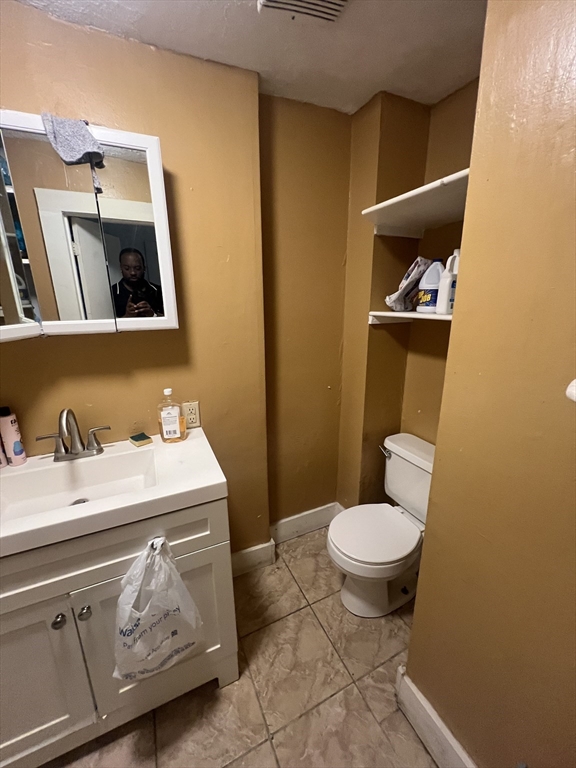 75 Intervale Street, Unit 1 Brockton, MA 02302 - Photo 3 of 11 a bathroom with a sink and a toilet
