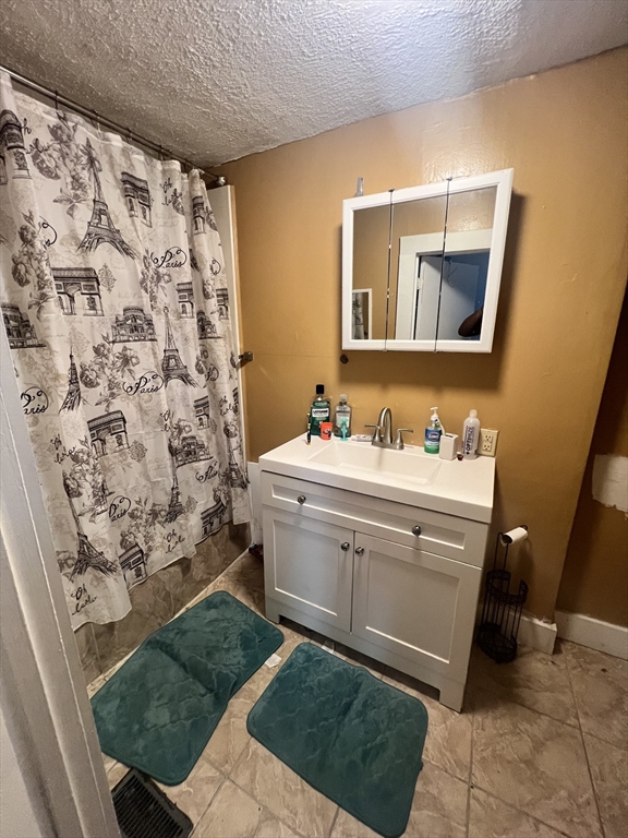 75 Intervale Street, Unit 1 Brockton, MA 02302 - Photo 7 of 11 a bathroom with a sink mirror and a bathtub