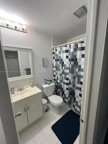 a room with lots of potted plants and wooden floor