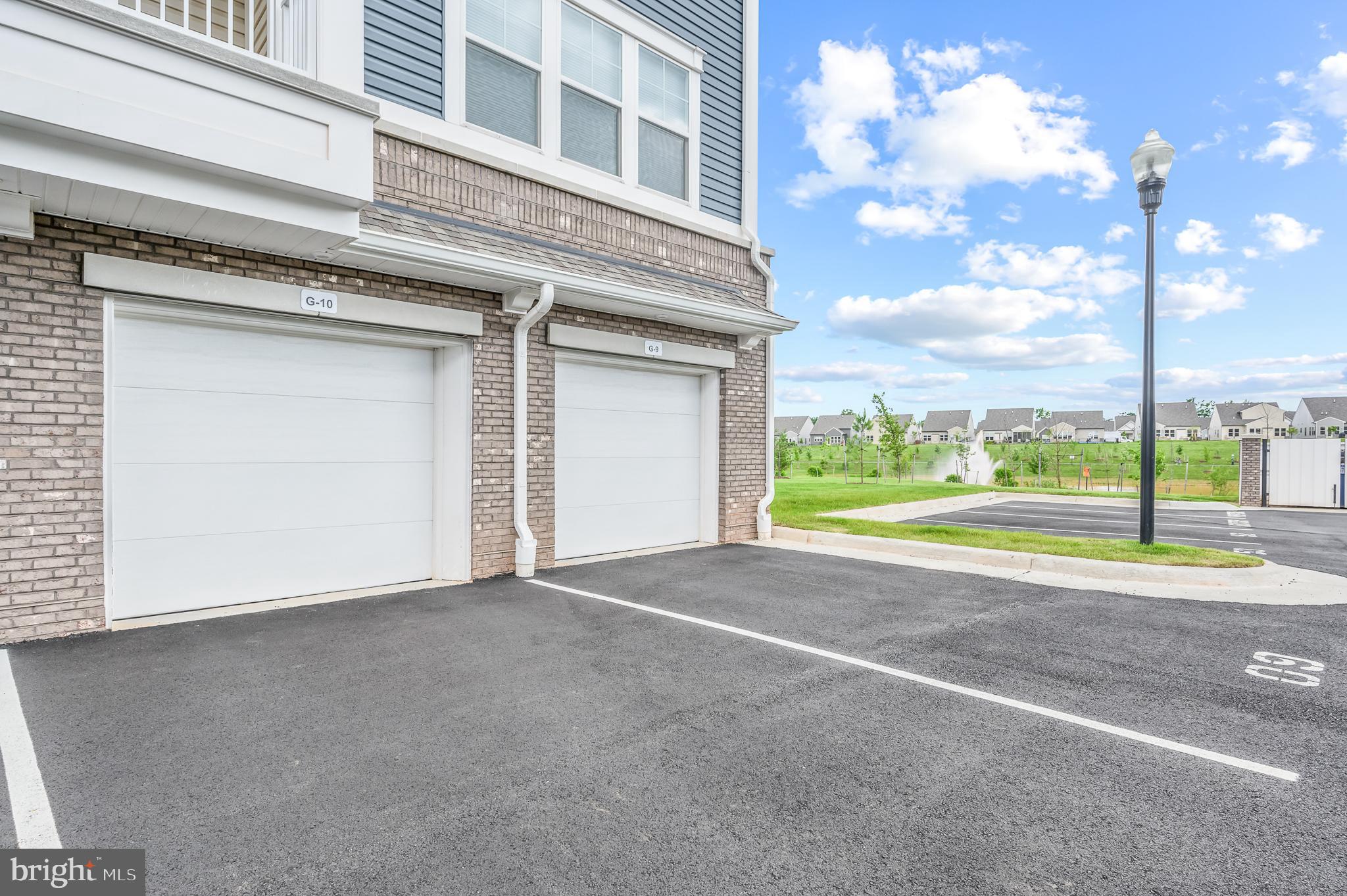 21894 Hawksbill High Circle, Unit 201 Sterling, VA 20164 - Photo 30 of 54 Extra parking in driveway behind garage