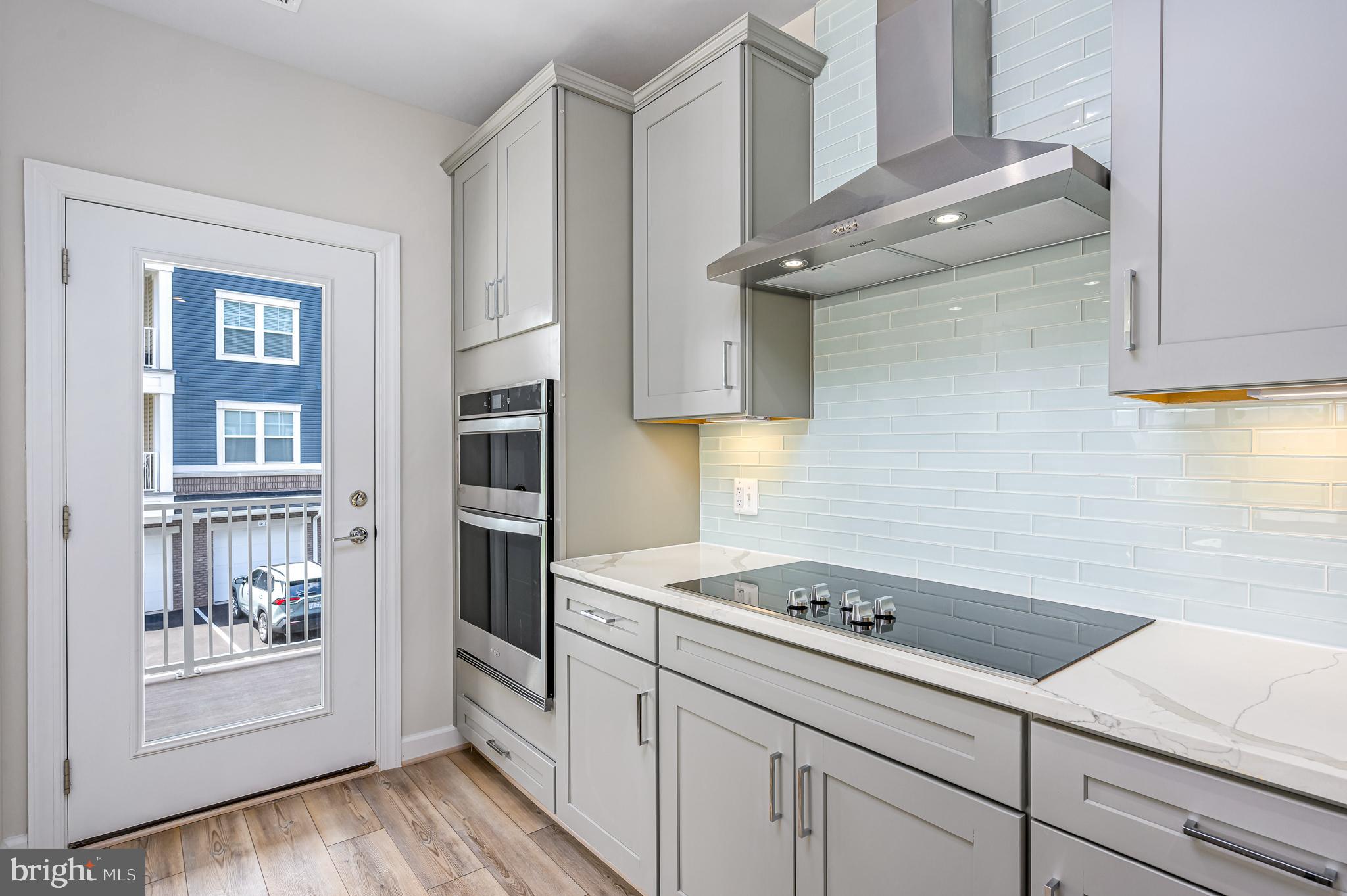 21894 Hawksbill High Circle, Unit 201 Sterling, VA 20164 - Photo 8 of 54 Door to spacious balcony area off kitchen