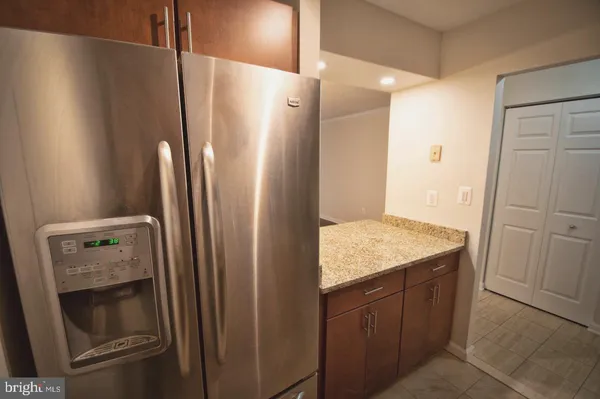 a kitchen with a refrigerator and cabinets
