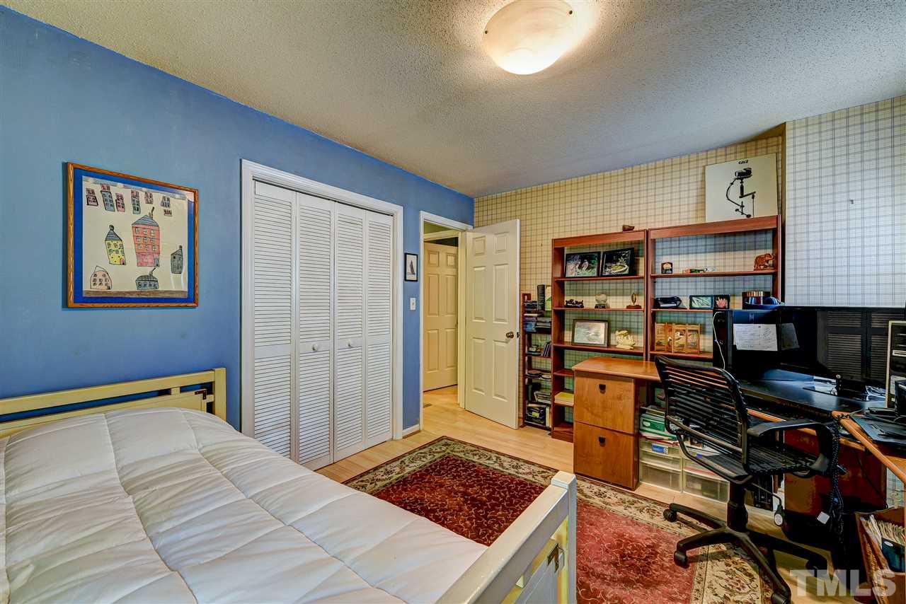6712 Perkins Drive Raleigh, NC 27612 - Photo 17 of 30 Bed Room 3 has bamboo flooring, closet, one window and door out to balcony porch. 13'6 x 10'7