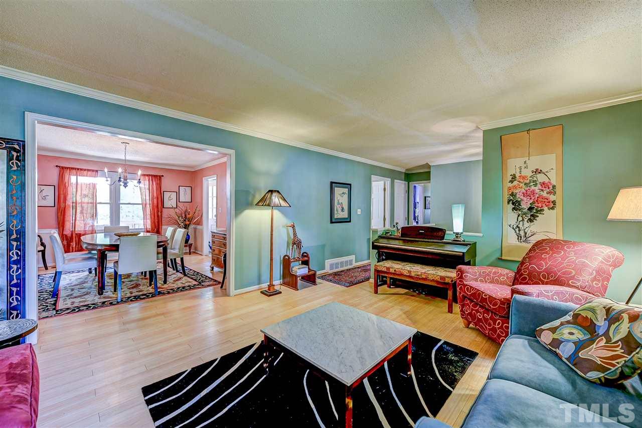 6712 Perkins Drive Raleigh, NC 27612 - Photo 7 of 30 16'11 x 13'6 Living room looking into dining room.