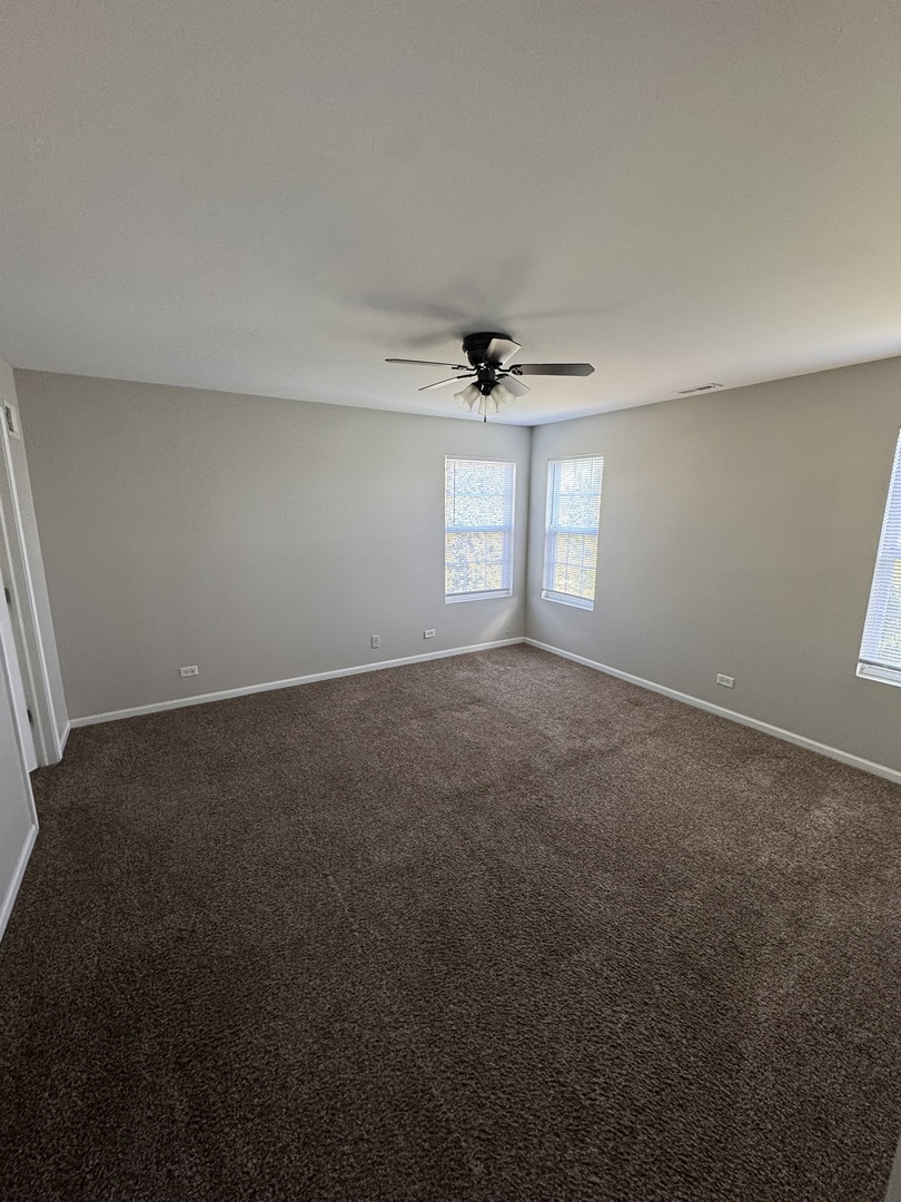 1401 Millbrook Drive Algonquin, IL 60102 - Photo 12 of 14 a view of a room with a ceiling fan and a window