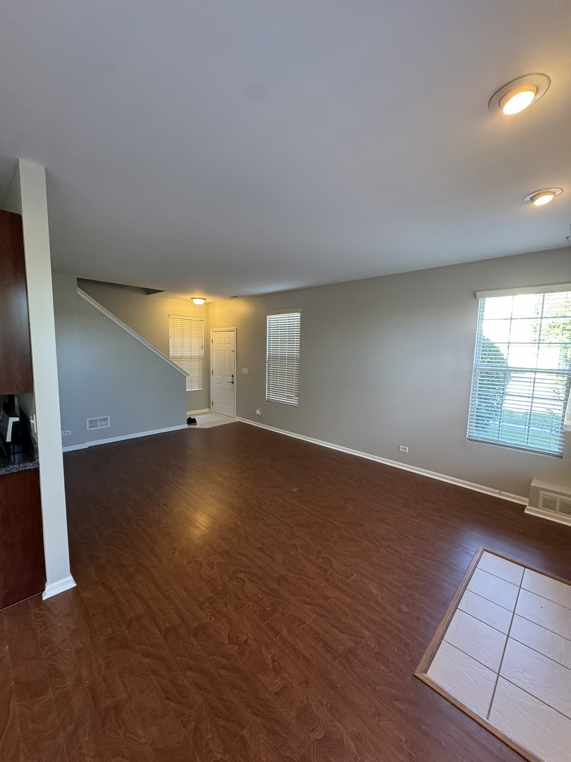 1401 Millbrook Drive Algonquin, IL 60102 - Photo 4 of 14 an empty room with wooden floor and windows