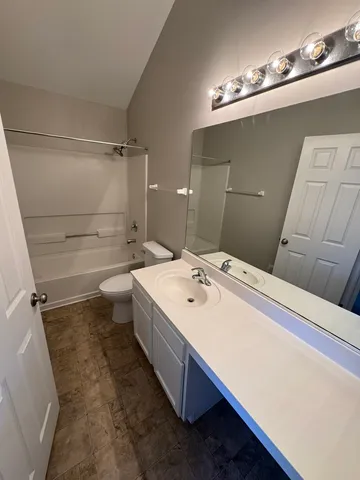 a bathroom with a sink a toilet and mirror