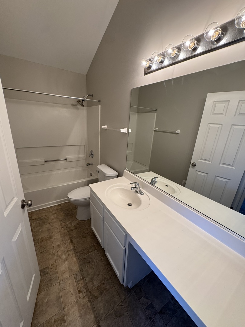 1401 Millbrook Drive Algonquin, IL 60102 - Photo 9 of 14 a bathroom with a sink a toilet and mirror
