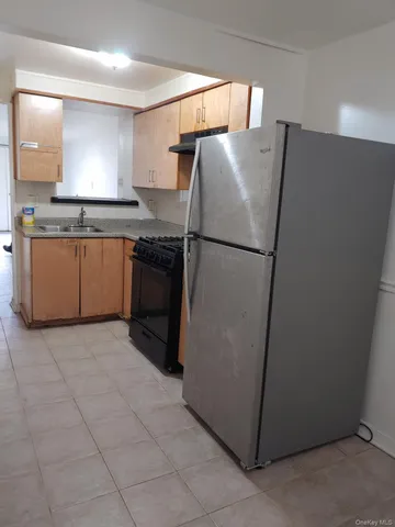 a white refrigerator freezer sitting in a kitchen