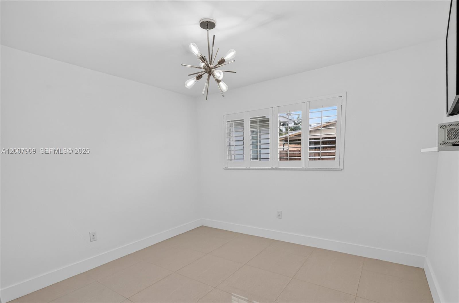 4865 Southwest 94th Avenue Miami, FL 33165 - Photo 14 of 32 an empty room with windows and fan