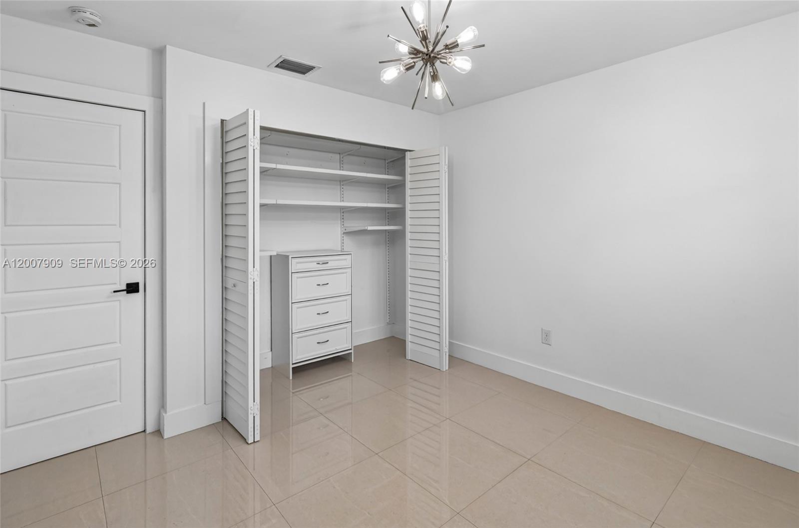 4865 Southwest 94th Avenue Miami, FL 33165 - Photo 15 of 32 a view of an empty room with a ceiling fan