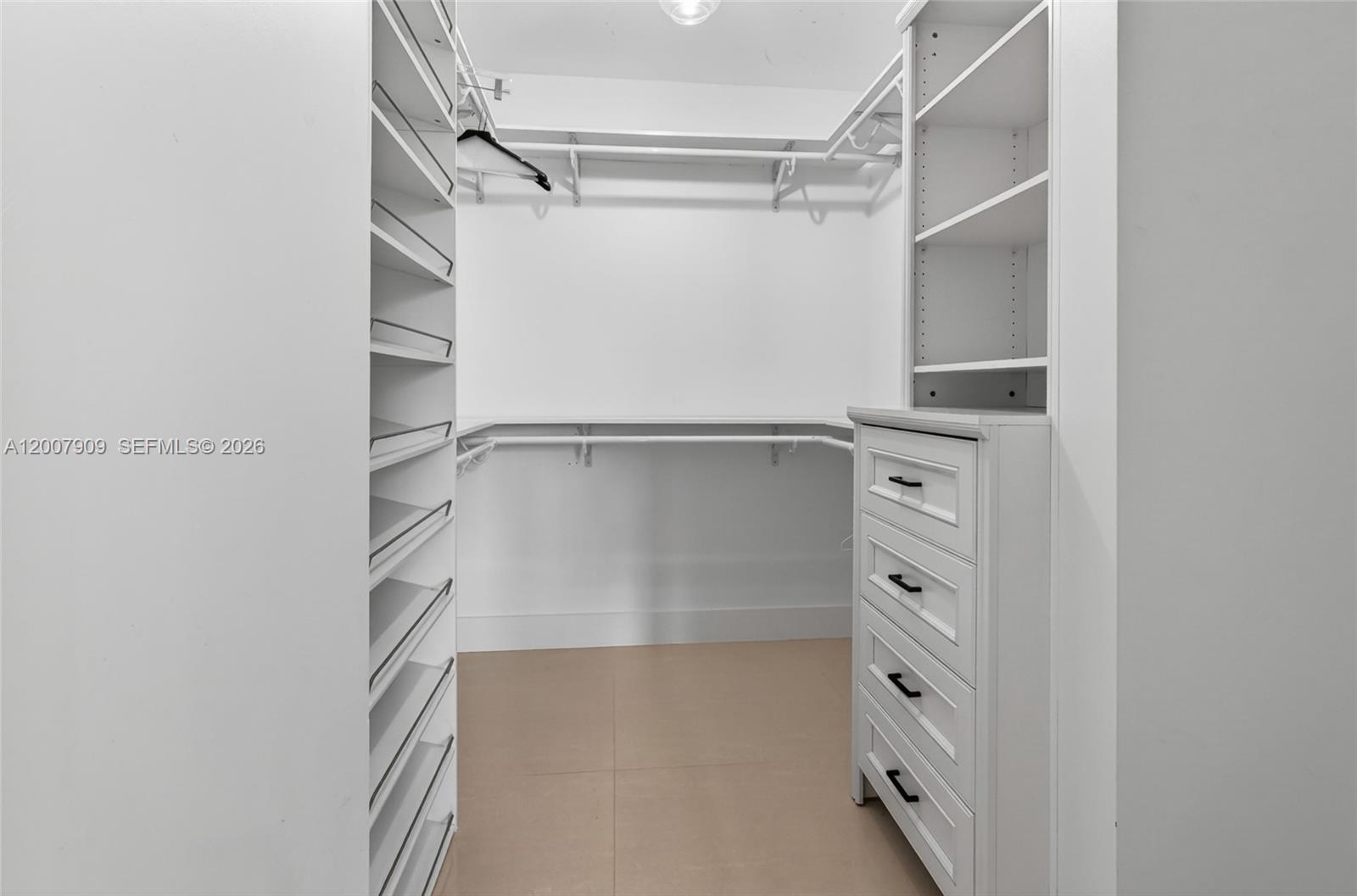 4865 Southwest 94th Avenue Miami, FL 33165 - Photo 21 of 32 a view of walk in closet with empty racks
