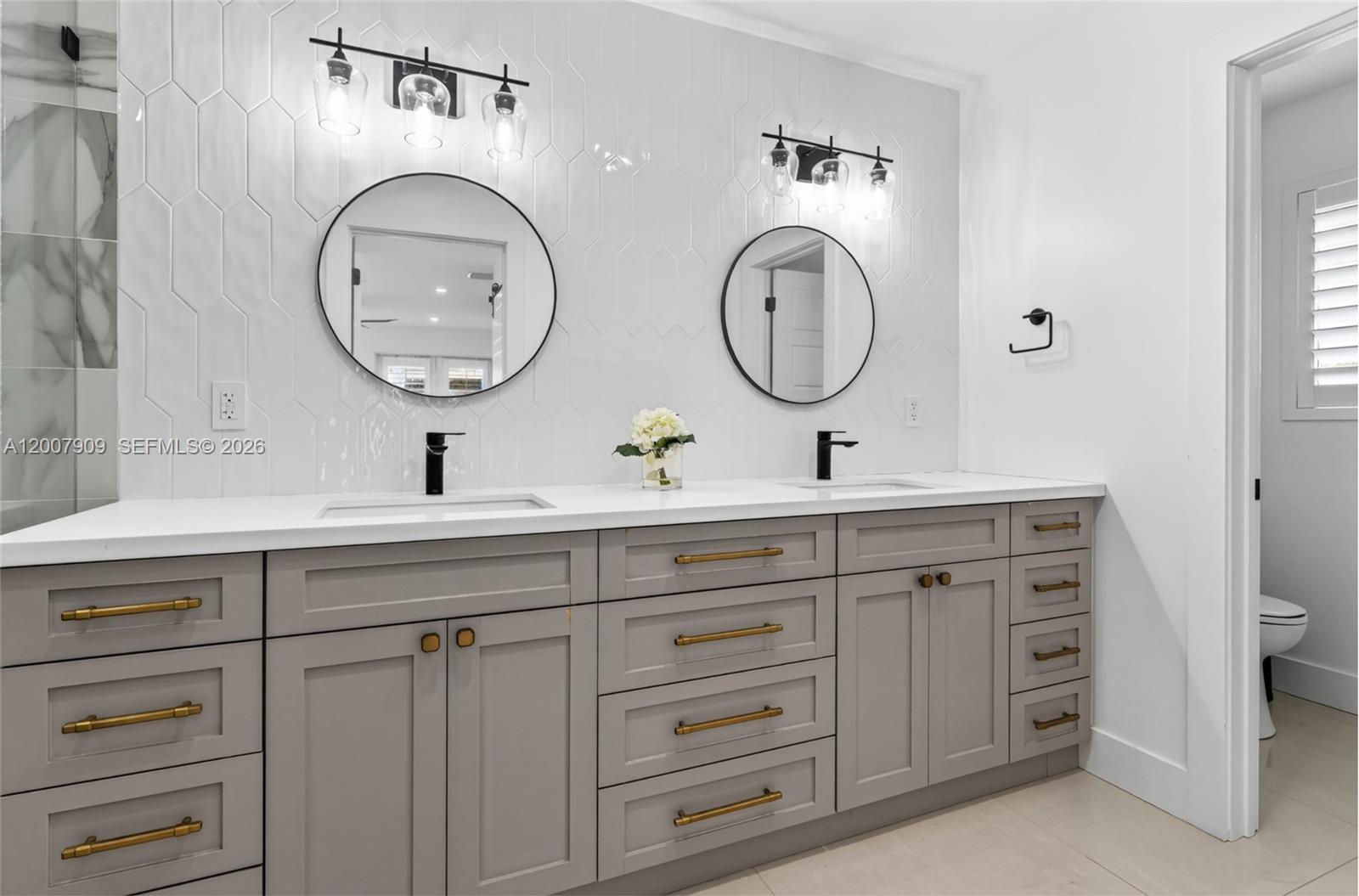 4865 Southwest 94th Avenue Miami, FL 33165 - Photo 23 of 32 a bathroom with a granite countertop double vanity sink and a mirror