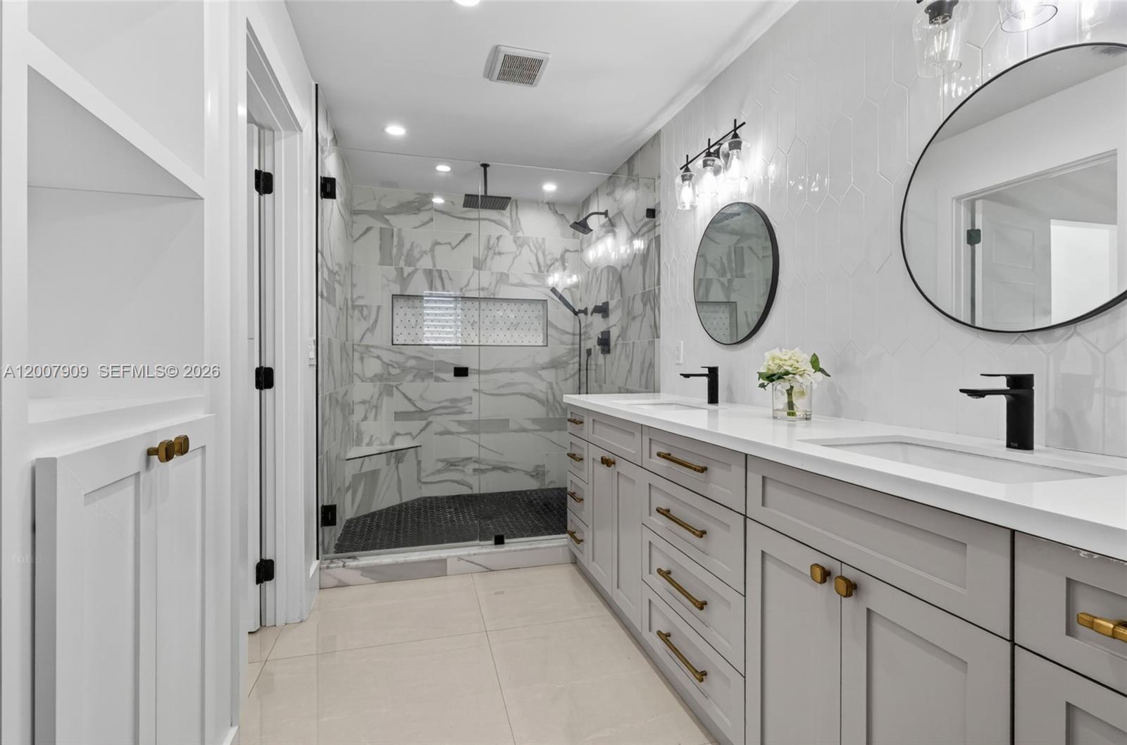 4865 Southwest 94th Avenue Miami, FL 33165 - Photo 24 of 32 a spacious bathroom with a double vanity sink mirror and shower
