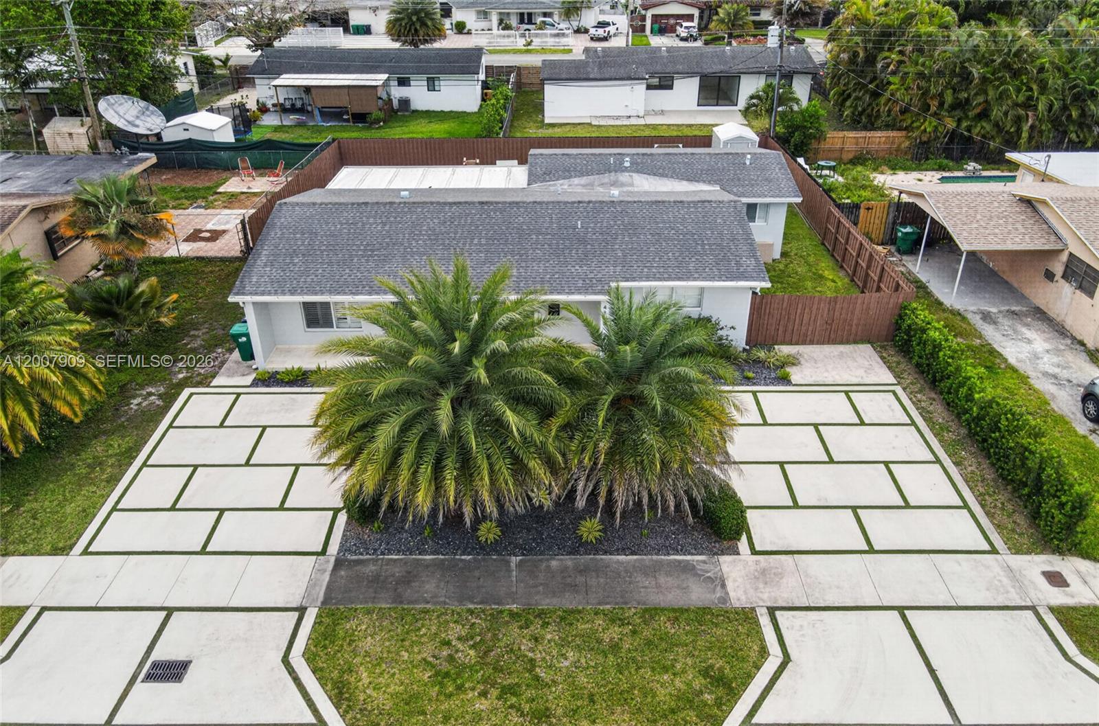 4865 Southwest 94th Avenue Miami, FL 33165 - Photo 29 of 32 a picture of houses with a yard