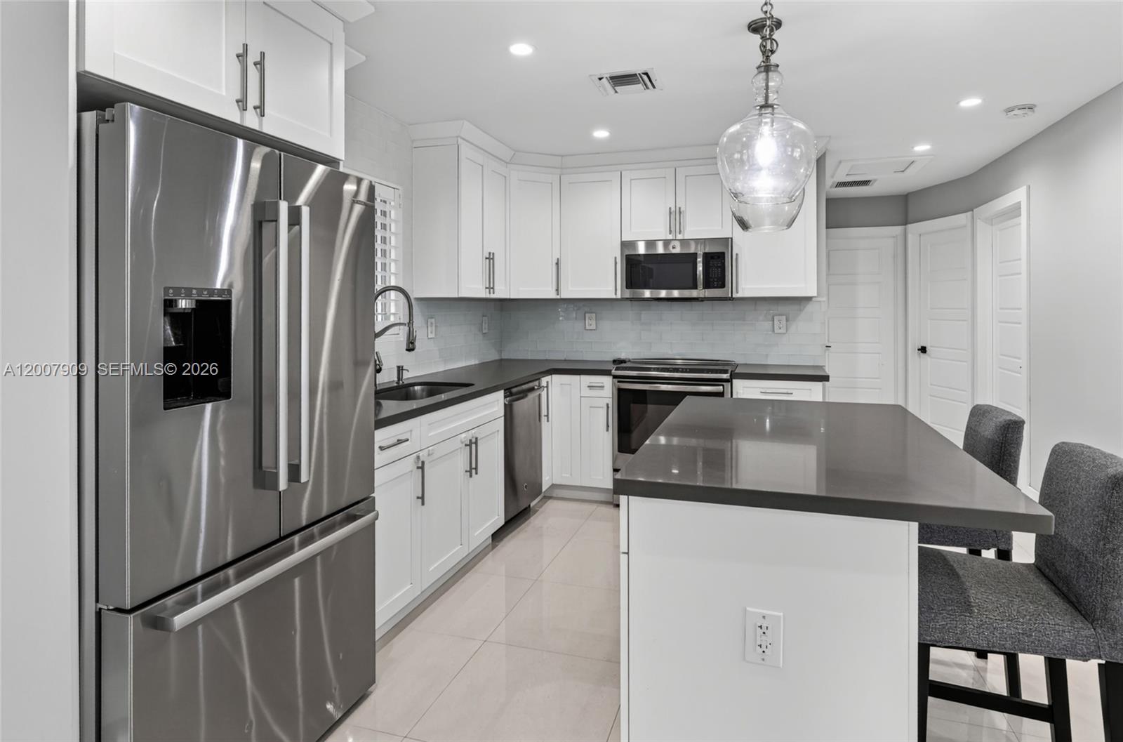 4865 Southwest 94th Avenue Miami, FL 33165 - Photo 9 of 32 a kitchen with stainless steel appliances granite countertop a refrigerator a sink a stove a microwave and a refrigerator