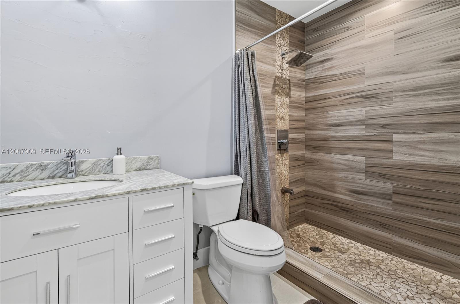 4865 Southwest 94th Avenue Miami, FL 33165 - Photo 10 of 32 a bathroom with a granite countertop sink toilet and shower