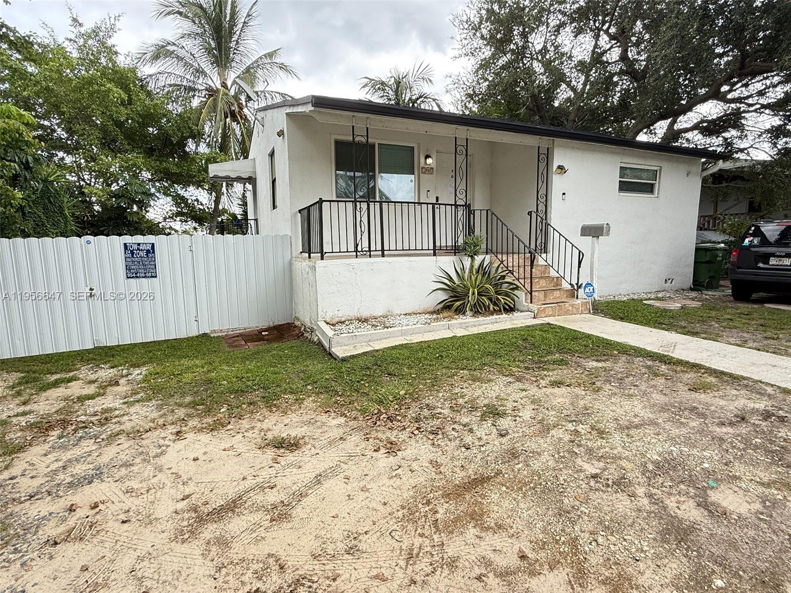707 Southwest 8th Avenue Hallandale Beach, FL 33009 - Photo 2 of 3 a view of a house with a yard