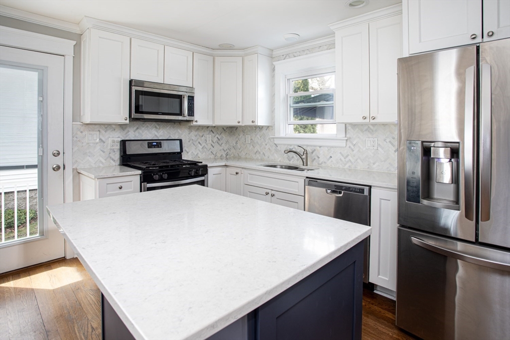 32 Oakland Street Fall River, MA 02720 - Photo 16 of 35 a kitchen with stainless steel appliances a refrigerator stove microwave and sink