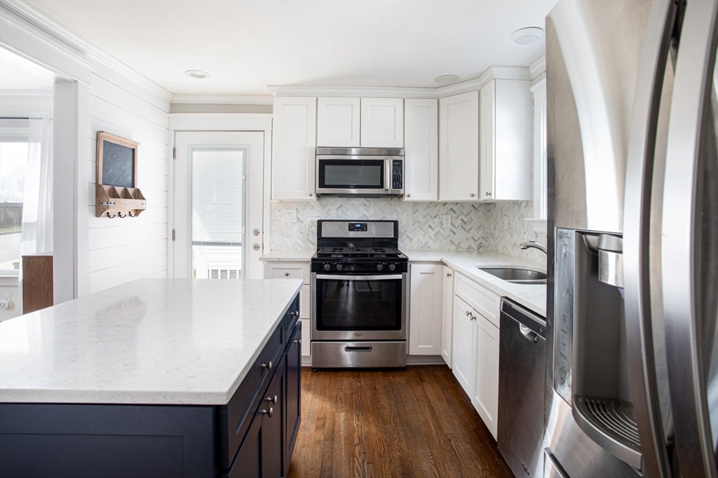 32 Oakland Street Fall River, MA 02720 - Photo 17 of 35 a kitchen with granite countertop a sink stove and refrigerator
