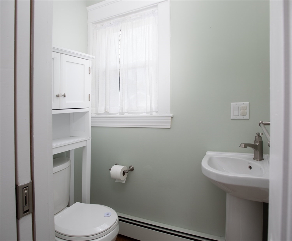 32 Oakland Street Fall River, MA 02720 - Photo 19 of 35 a bathroom with a sink a toilet and a mirror