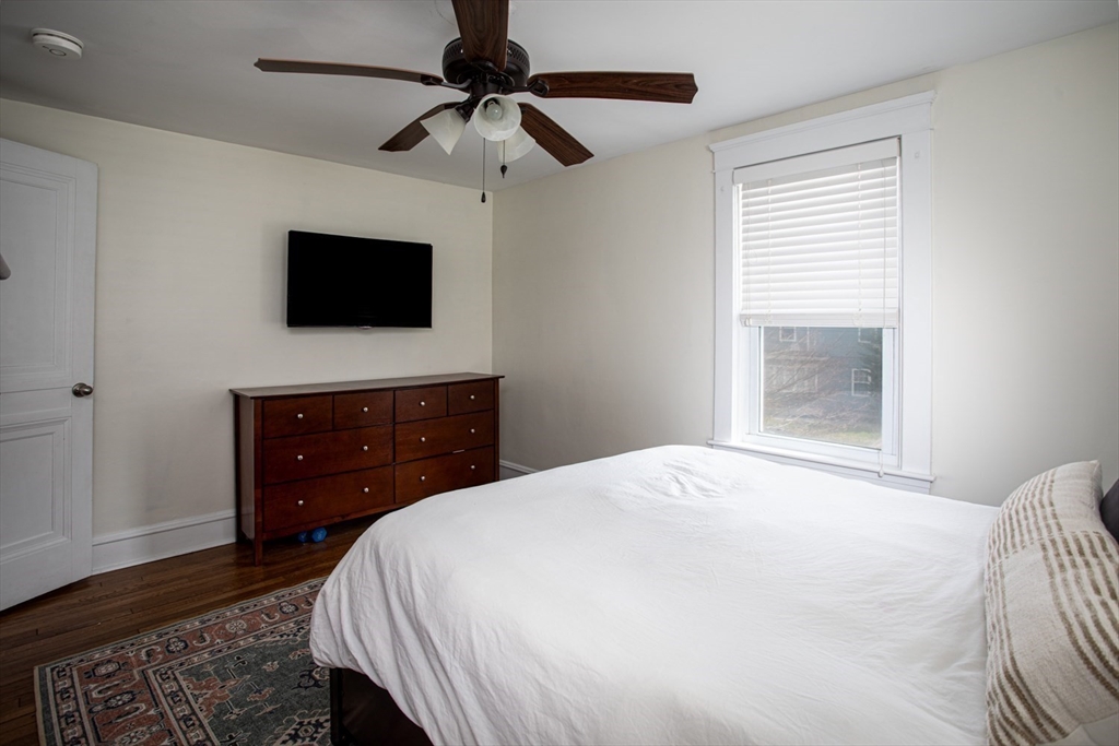 32 Oakland Street Fall River, MA 02720 - Photo 28 of 35 a bedroom with a bed a flat screen tv and a window