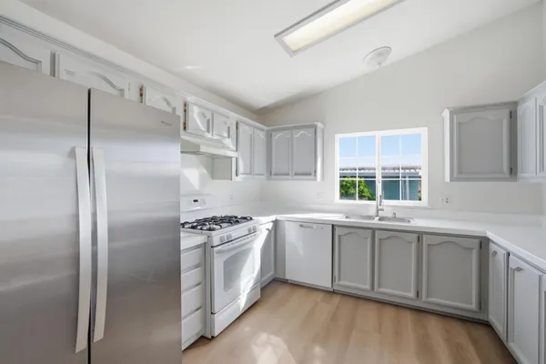 a kitchen with a sink stainless steel appliances and cabinets