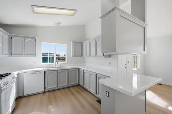 a kitchen with a sink cabinets and appliances