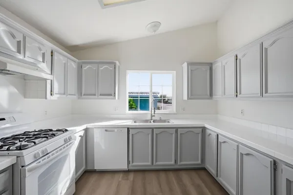 a kitchen with a sink stove and cabinets