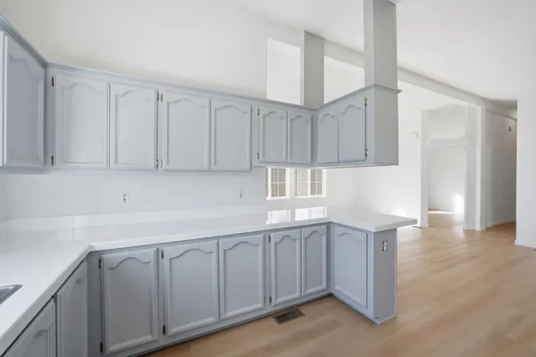 a kitchen with white cabinets