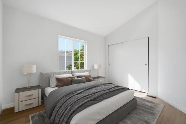 a bedroom with a bed and a window