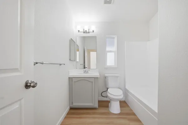 a bathroom with a toilet sink and a mirror