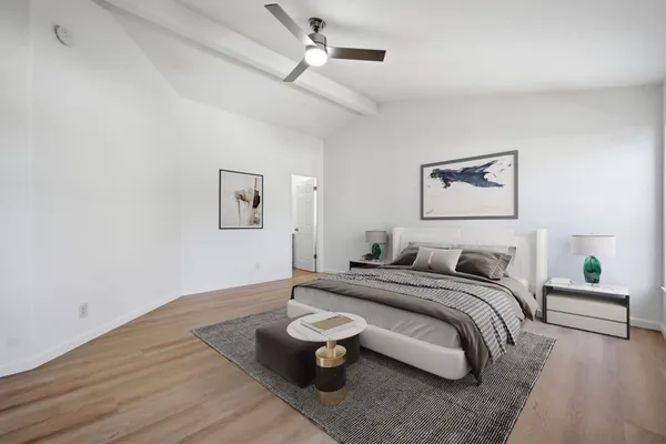 a bedroom with a bed and lamp