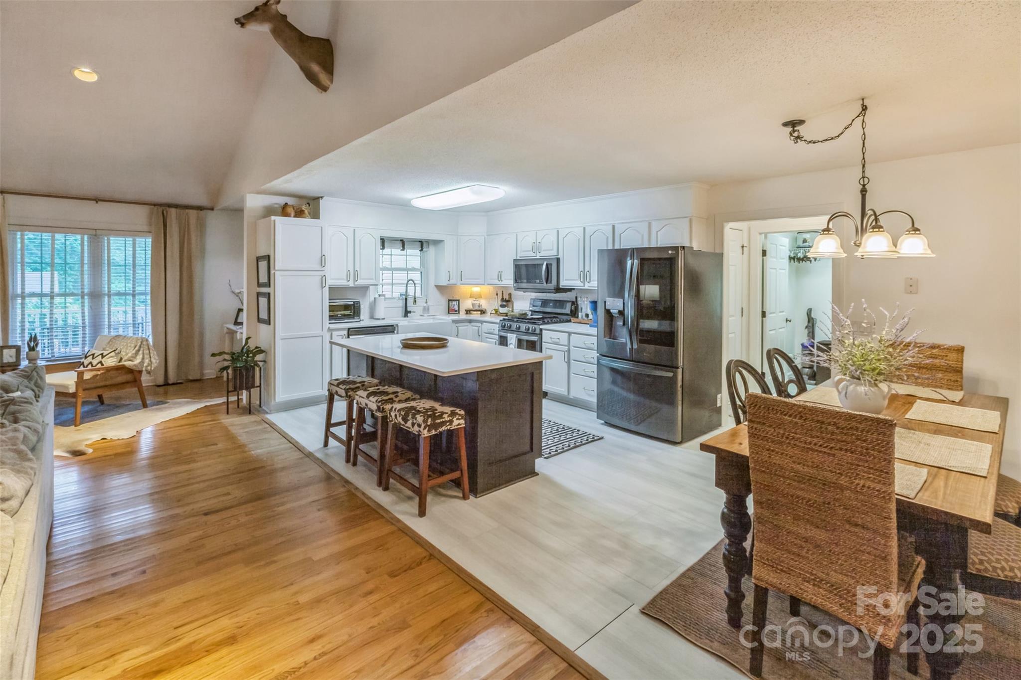 150 Marys Lane Rutherfordton, NC 28139 - Photo 12 of 35 a kitchen with stainless steel appliances granite countertop a refrigerator a sink dishwasher a stove and a dining table with wooden floor