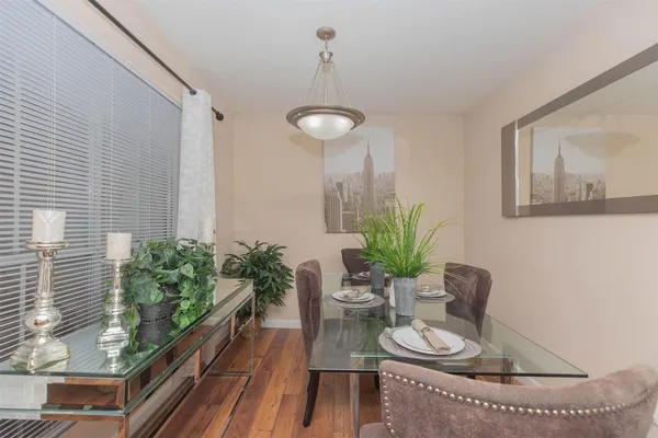 a dining room with furniture and potted plants