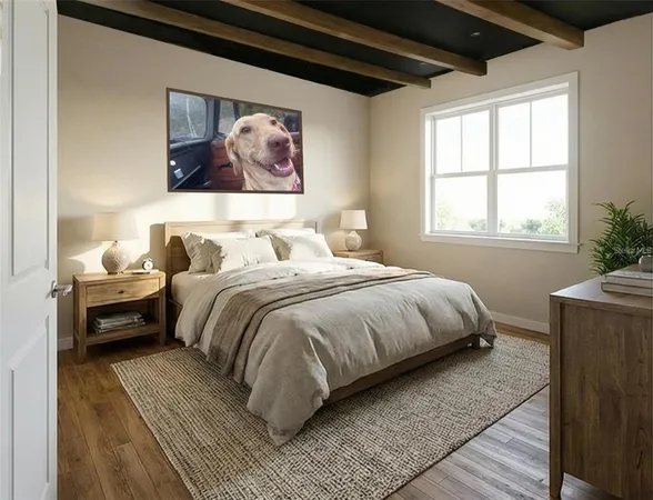 a bedroom with a bed and a painting on the wall