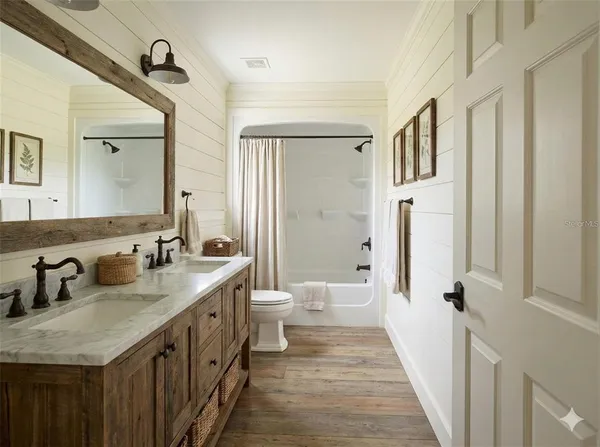 a bathroom with a double vanity sink and a mirror