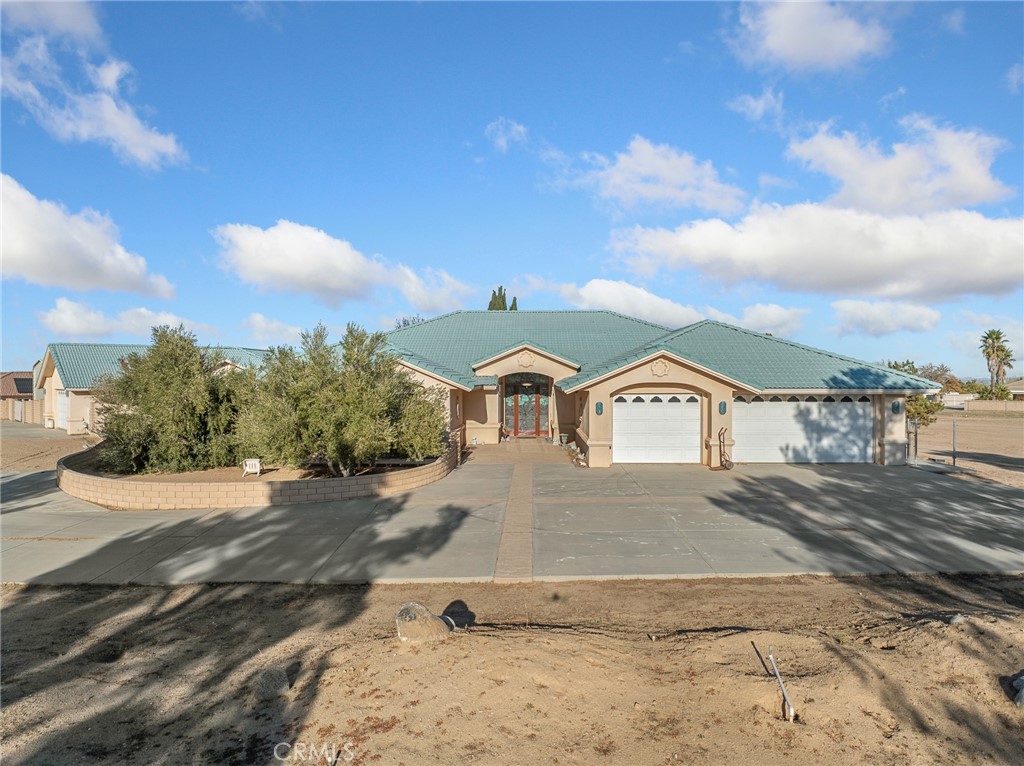 7139 Foley Road Oak Hills, CA 92344 - Photo 12 of 72 a front view of a house with a yard
