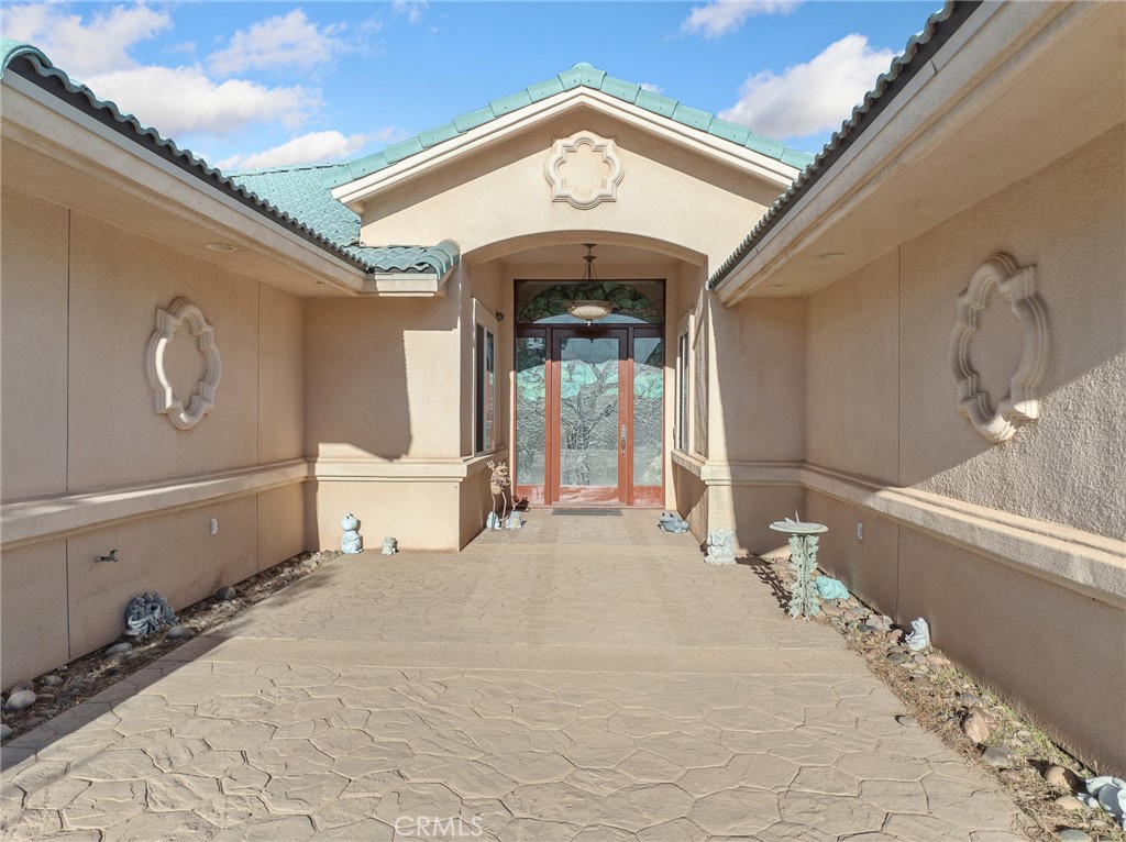 7139 Foley Road Oak Hills, CA 92344 - Photo 13 of 72 a view of a white building with a outdoor space