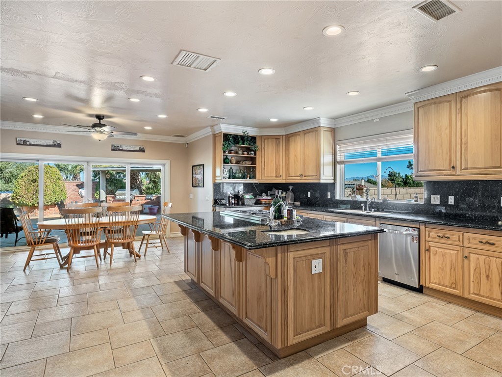 7139 Foley Road Oak Hills, CA 92344 - Photo 20 of 72 a kitchen with lots of counter top space and dining table