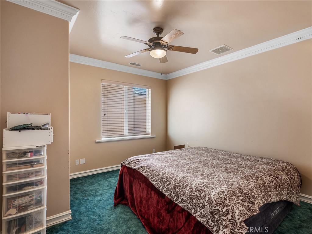 7139 Foley Road Oak Hills, CA 92344 - Photo 30 of 72 a bedroom with a bed and window