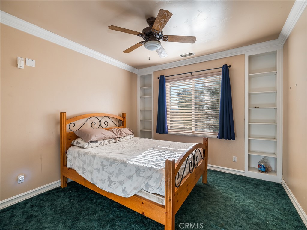 7139 Foley Road Oak Hills, CA 92344 - Photo 32 of 72 a bedroom with a bed and a window