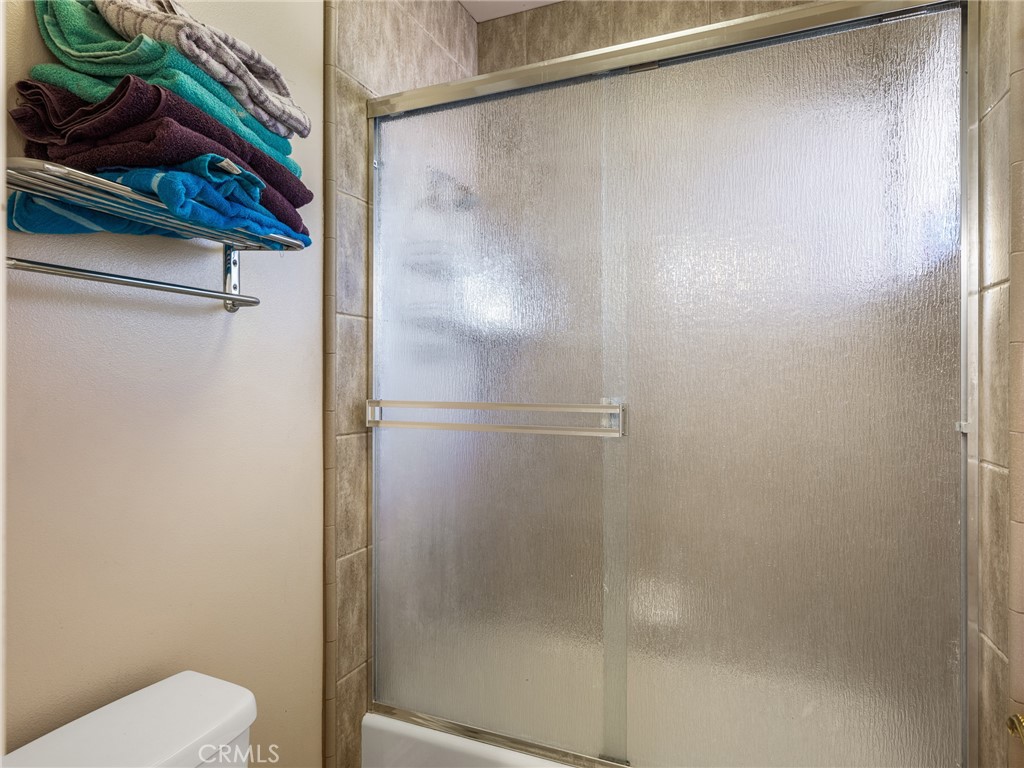 7139 Foley Road Oak Hills, CA 92344 - Photo 35 of 72 a bathroom with a shower and a toilet