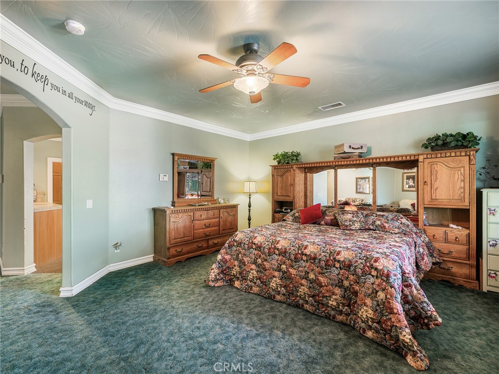 7139 Foley Road Oak Hills, CA 92344 - Photo 40 of 72 a bedroom with a bed and a chandelier