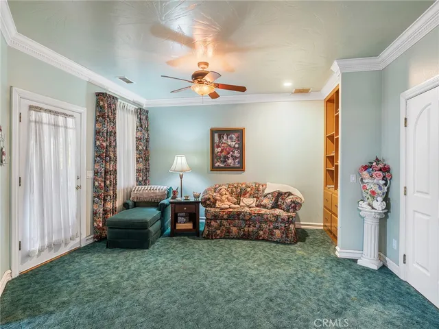 a view of a patio with a table and chairs under an umbrella