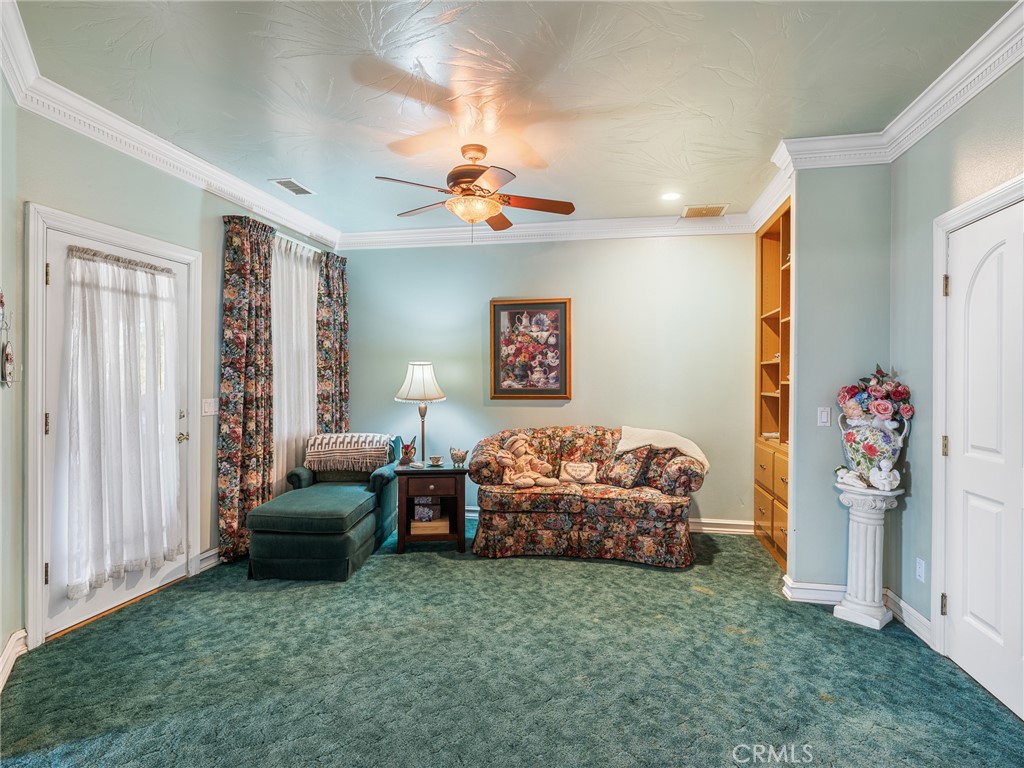 7139 Foley Road Oak Hills, CA 92344 - Photo 42 of 72 a living room with furniture and a chandelier