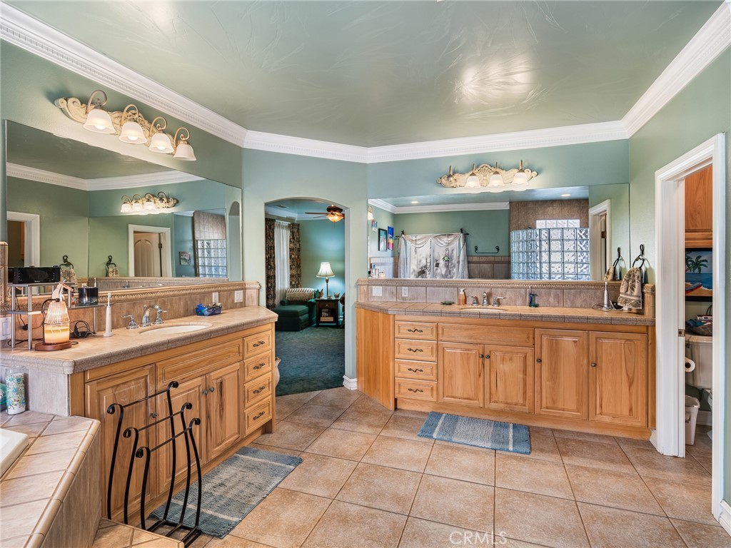 7139 Foley Road Oak Hills, CA 92344 - Photo 49 of 72 a room with kitchen island granite countertop a sink and cabinets