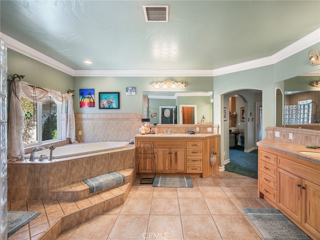 7139 Foley Road Oak Hills, CA 92344 - Photo 51 of 72 a large bathroom with a tub sink and mirror