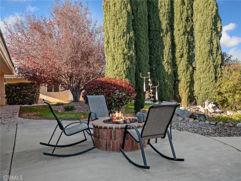 7139 Foley Road Oak Hills, CA 92344 - Photo 54 of 72 a view of a chairs and table in backyard